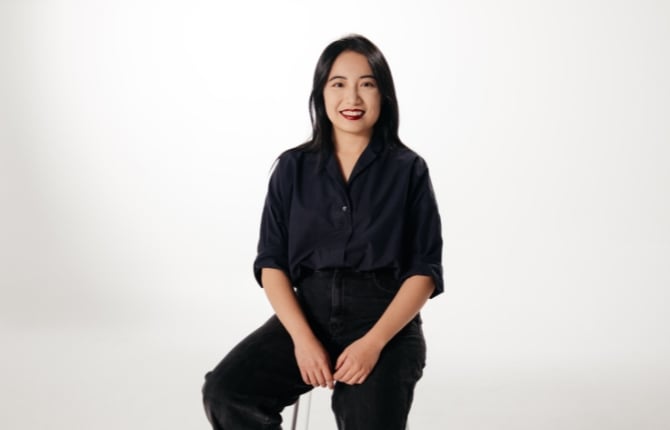 Chinese international graduate smiling at the camera